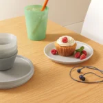 Set of four 6-inch black appetizer plates, perfect for serving snacks and appetizers.
