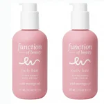 Two pink bottles of Function of Beauty's customizable curl cream for curly hair, formulated with Moringa oil.