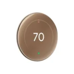 Google Nest Learning Thermostat 4th Gen in Polished Gold, showcasing its large display and sleek design.