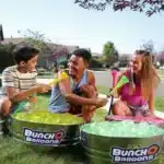 100 Zuru Bunch O Balloons in red, white, and blue, ready for a summer water fight. Self-sealing design for easy filling.