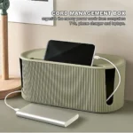 Large green/white cable management box with ventilation holes, hiding power cords under desk. Neat and organized workspace.