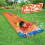 Kids having fun on a blue and orange NERF Super Soaker Blast 12ft water slide.
