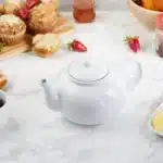 Classic white RSVP International 16oz stoneware teapot, microwave & dishwasher safe. Enjoy the perfect cuppa!