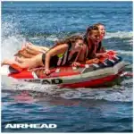 Airhead G-Force Inflatable Towable on open water Riders enjoying Airhead G-Force Inflatable Towable behind boat Airhead G-Force Inflatable Towable close-up of grip handles Airhead G-Force Inflatable Towable being towed on a lake Airhead G-Force Inflatable Towable durable construction detail