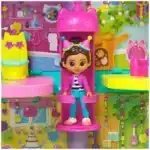 Gabby's Dollhouse Toy packaging front view Child playing with Gabby's Dollhouse Toy Gabby's Dollhouse Toy gift idea for kids Close-up details of Gabby's Dollhouse Toy Official Gabby's Dollhouse Toy for imaginative play