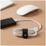 vegan leather cable organizer by U Brands on desk vegan leather cable organizer for tidy charging cables vegan leather cable organizer closeup of stitching detail vegan leather cable organizer holding USB and power cords vegan leather cable organizer minimalist workspace accessory