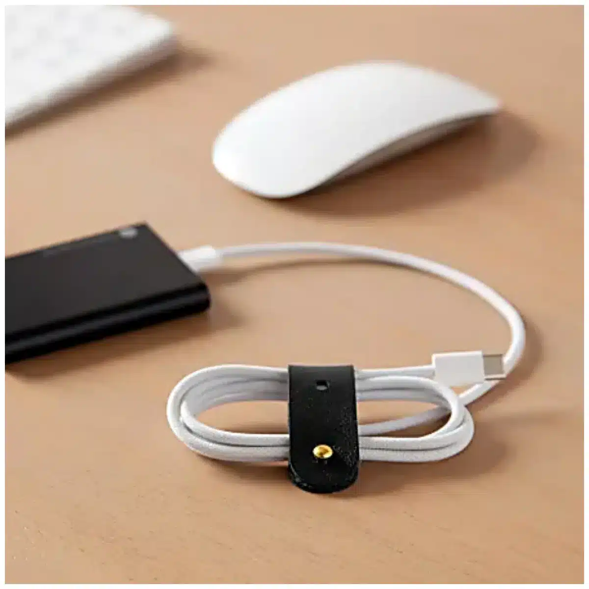 vegan leather cable organizer by U Brands on desk vegan leather cable organizer for tidy charging cables vegan leather cable organizer closeup of stitching detail vegan leather cable organizer holding USB and power cords vegan leather cable organizer minimalist workspace accessory