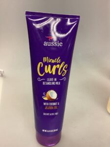 Aussie Miracle Curls Frizz Taming Cream with Coconut and Jojoba Oil.
