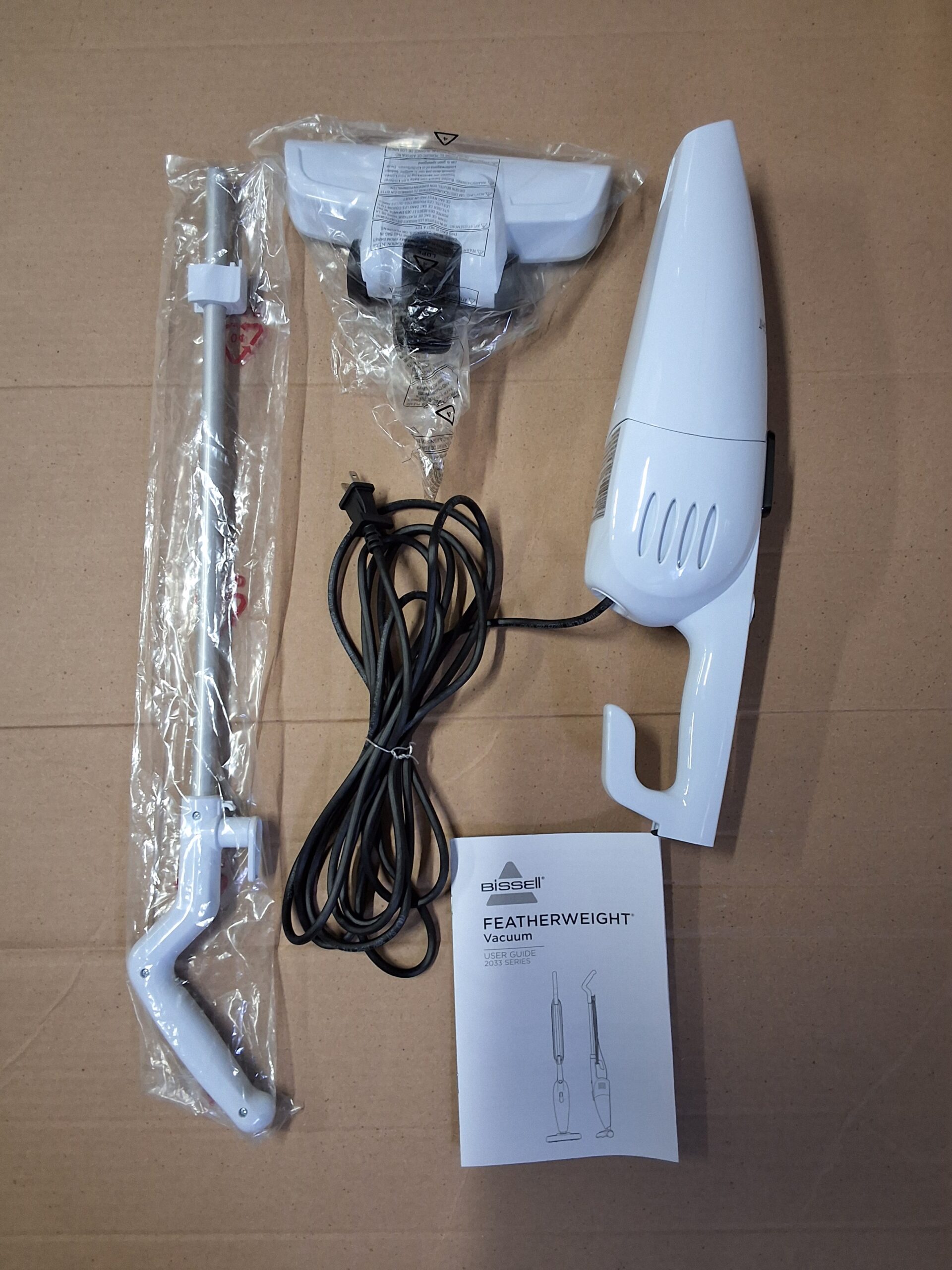 Bissell stick vacuum in featherweight white ultra-lightweight and compact design