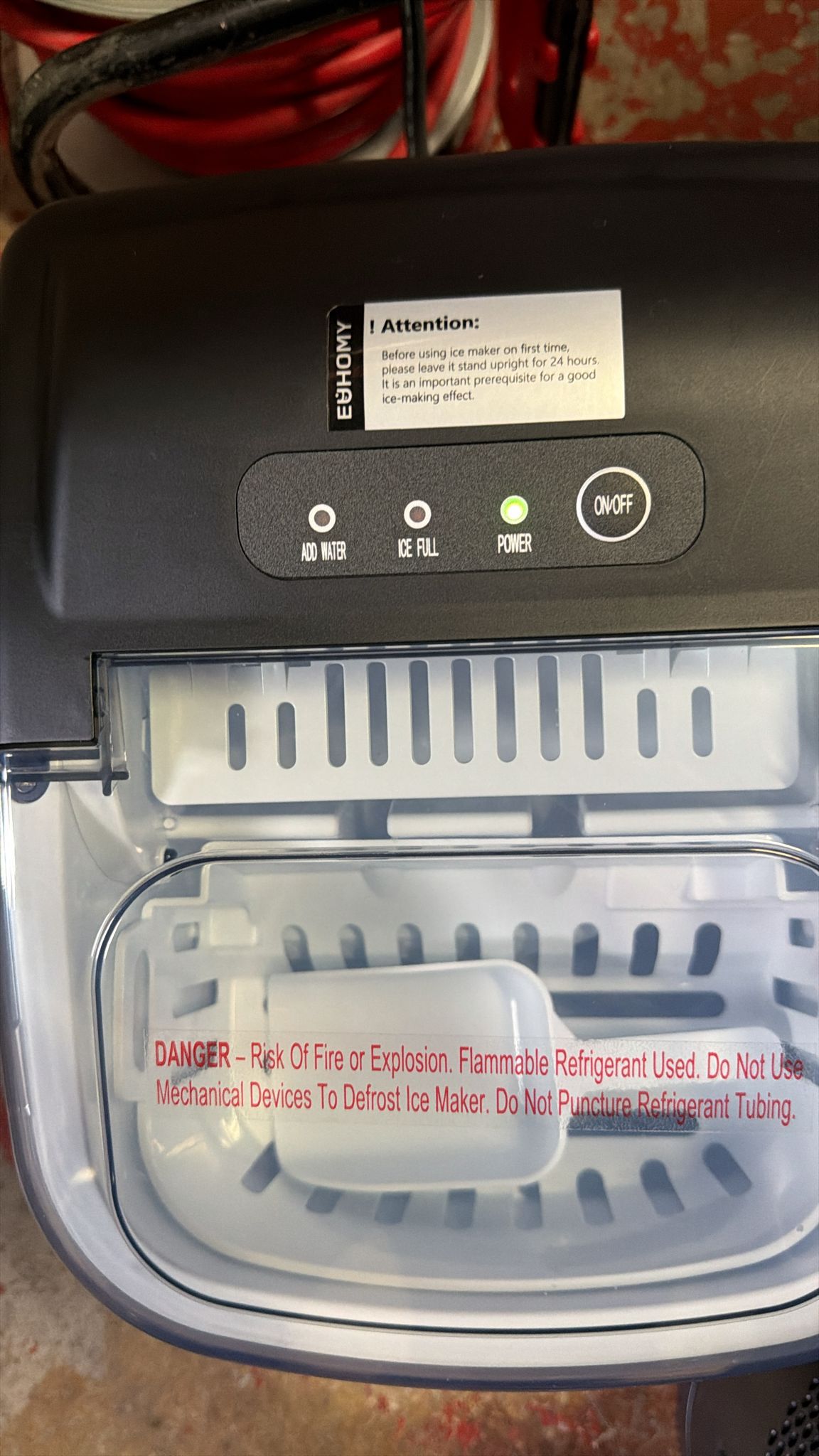 Euhomy countertop ice maker in black with handle and ice basket