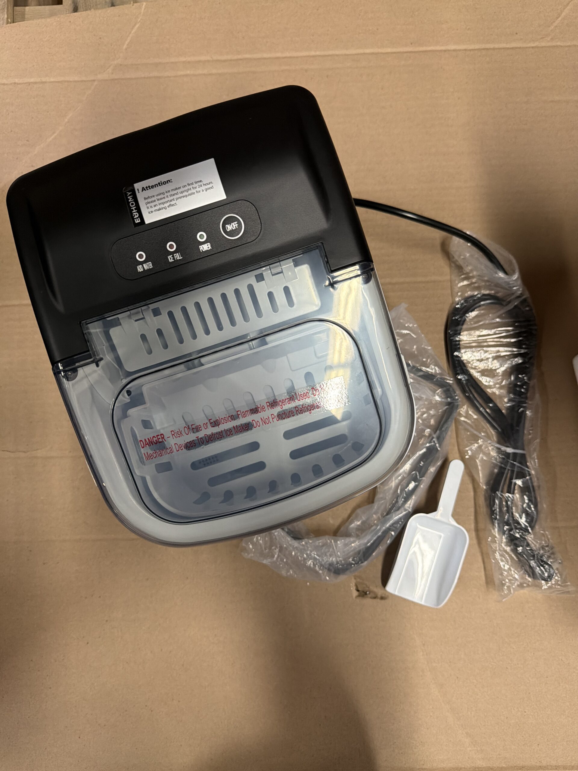 Euhomy countertop ice maker in black with handle and ice basket