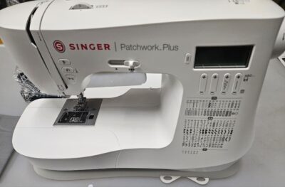 SINGER computerized sewing machine in sleek design with extension table