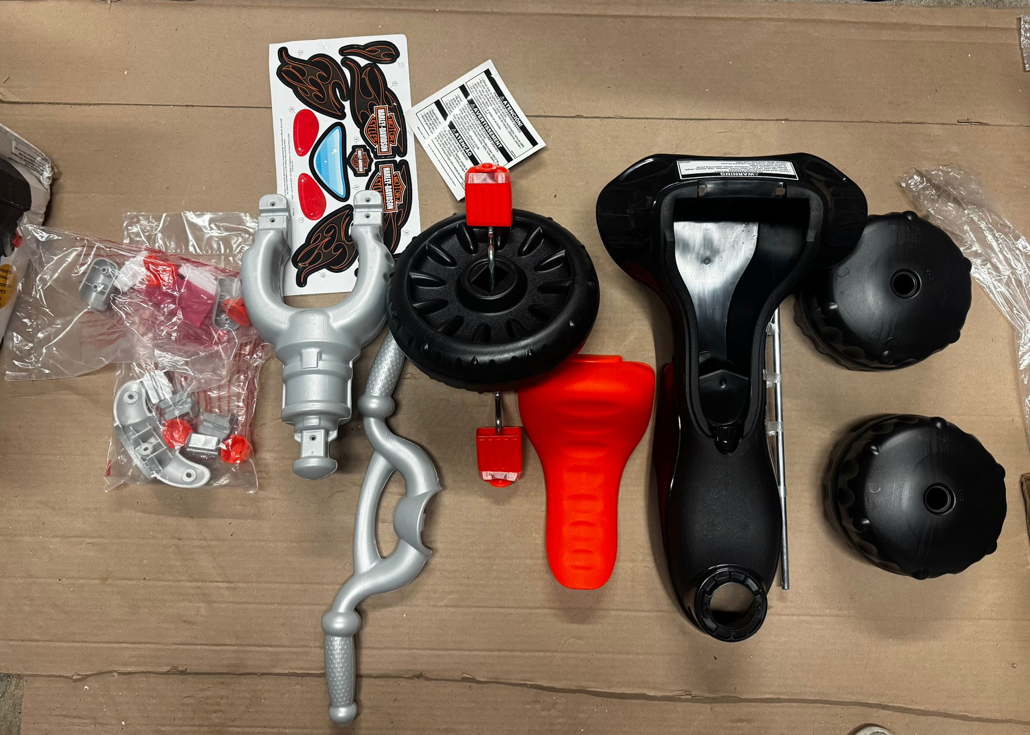 Fisher-Price toddler tricycle in Harley-Davidson design with handlebar grips and storage