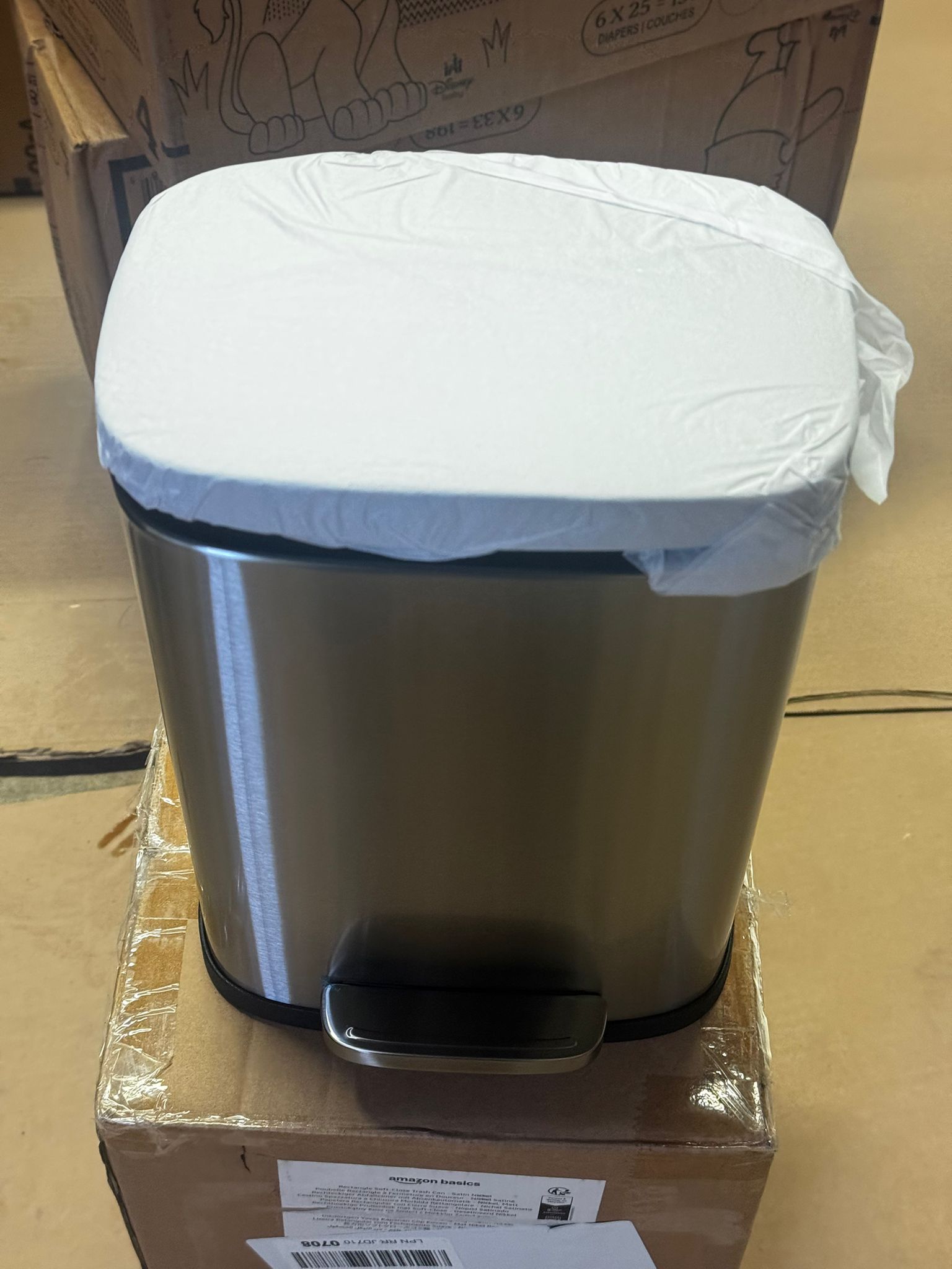 Amazon Basics small rectangular trash can in satin nickel finish with soft-close foot pedal