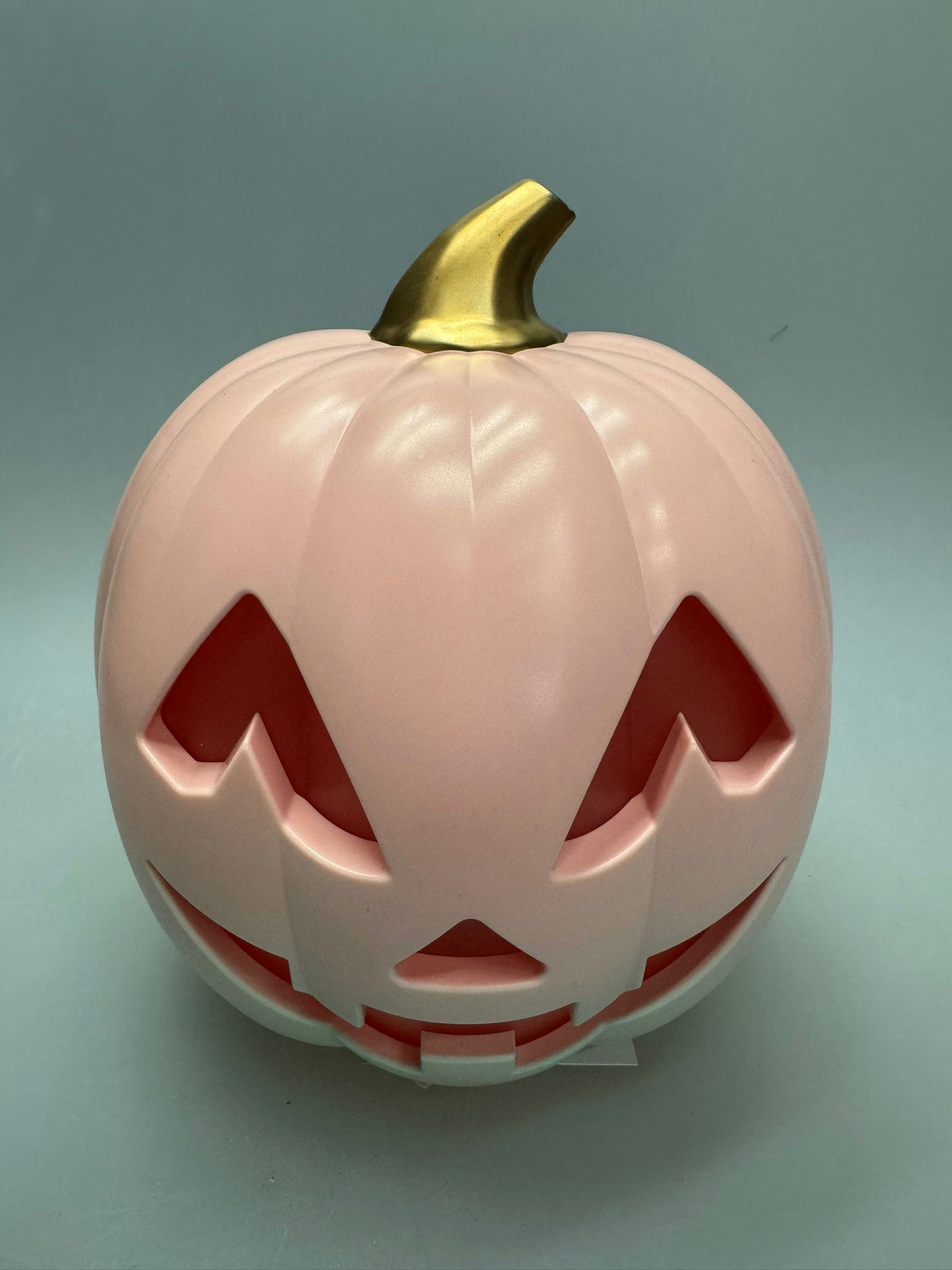 Halloween jack-o-lantern pumpkin figurines in pink festive style