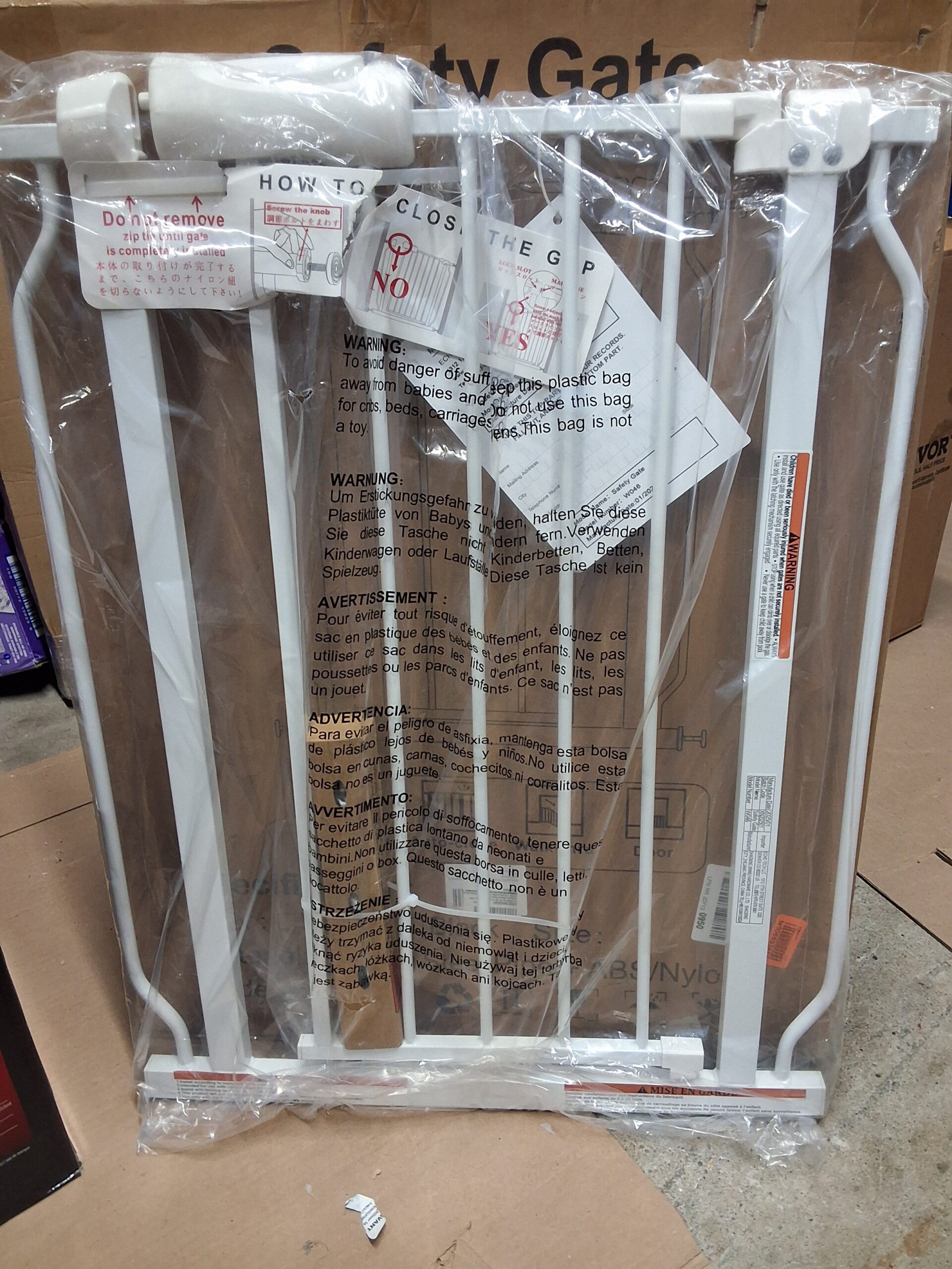 baby gate pressure mounted in white metal for stairs and doorways