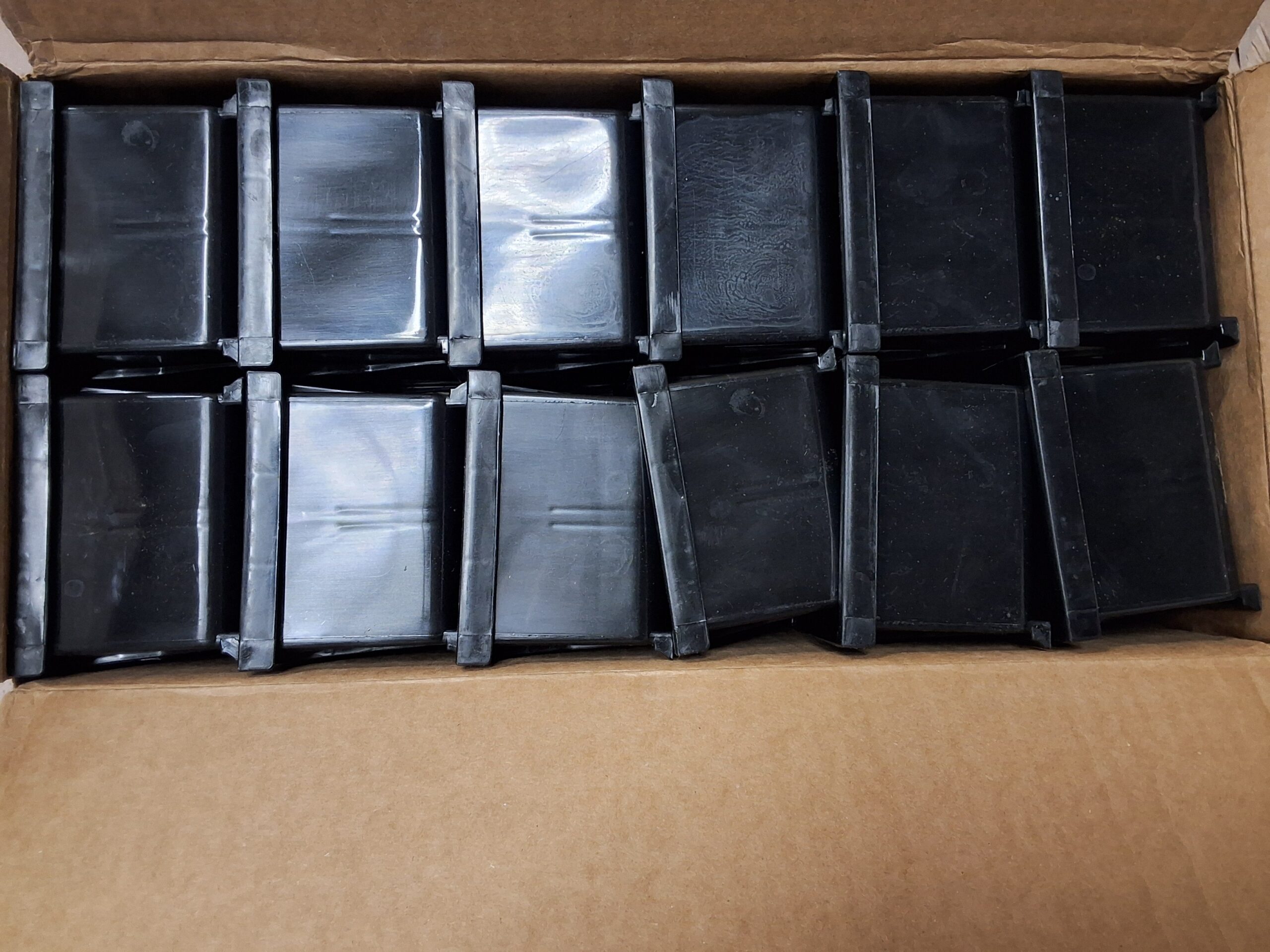 Akro plastic storage bins in black, stackable and space-saving design