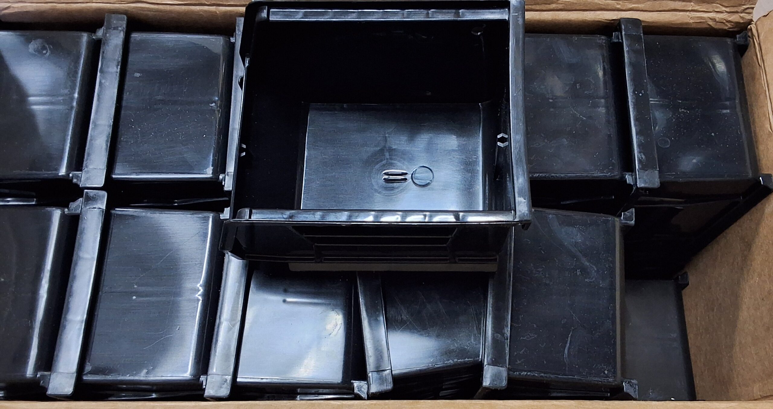 Akro plastic storage bins in black, stackable and space-saving design